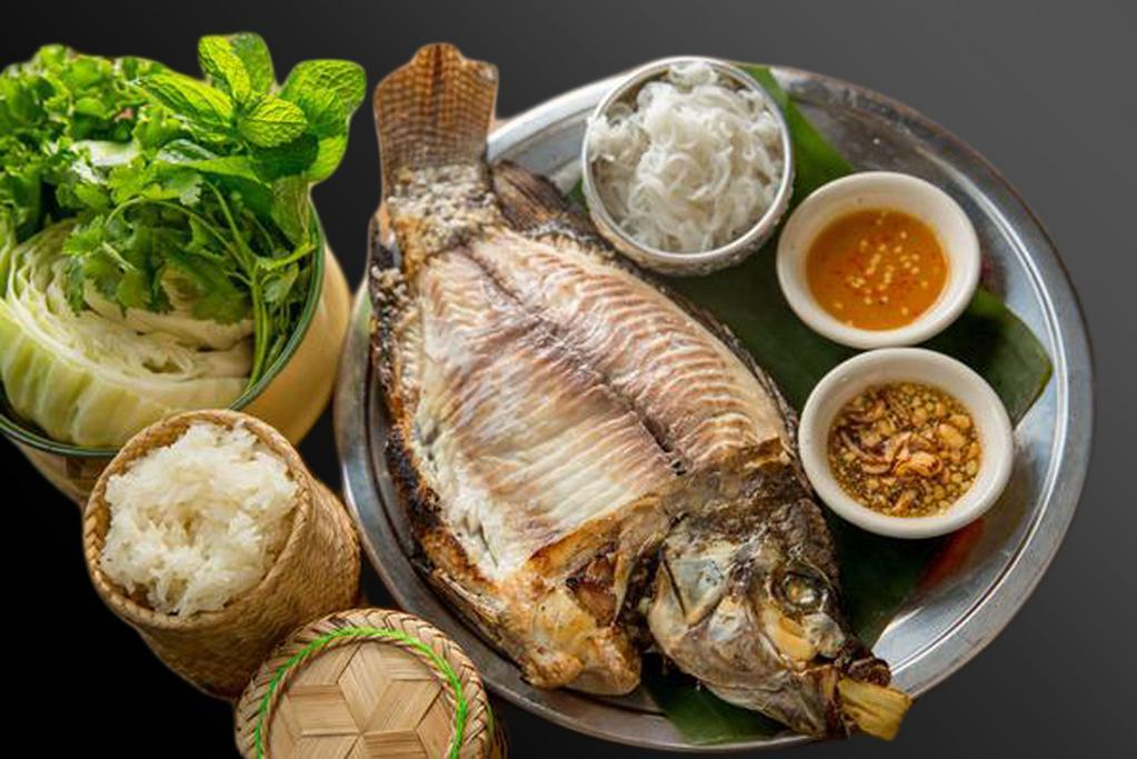 Pla Pao (Grilled whole fish) · Grilled Herbs Whole Tilapia served with fresh vegetables, vermicelli noodle and sticky rice.