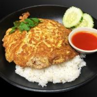 Omelette Over Rice · Egg omelette with grounded meat served over rice with sriracha sauce.