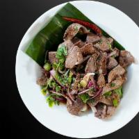 Pork livers Larb Salad · Light and spicy salad served warm with mints, shallots, scallions, cilantro, roasted rice po...