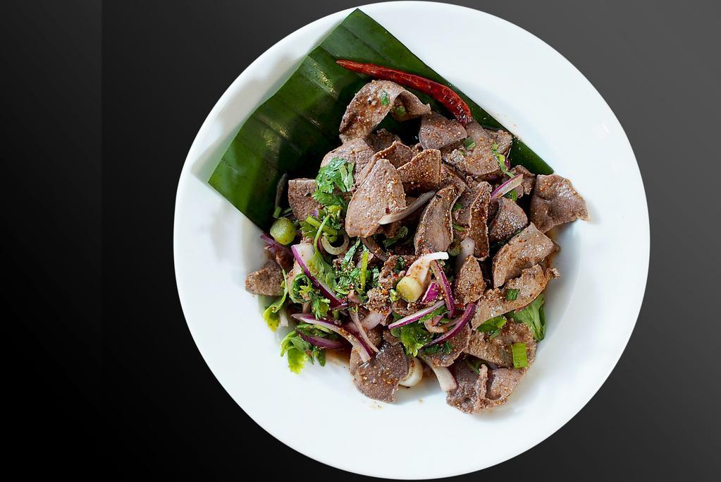 Pork livers Larb Salad · Light and spicy salad served warm with mints, shallots, scallions, cilantro, roasted rice powder with chili lime dressing.