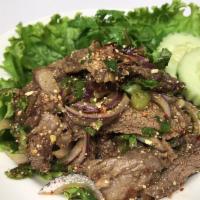 BBQ Beef Salad · Grilled Rib Eye beef salad with mints, shallots, scallions, cilantro, roasted rice powder wi...
