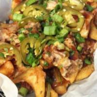 Dirty Fries · Beer battered signature fries, smoked pork, queso,  agave beer BBQ, and pickled jalapenos.