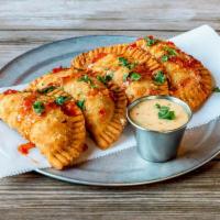 Chicken Empanadas · Smoked queso and chicken empanadas with a sweet chili mustard dipping sauce 