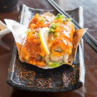 11. Volcano Roll · 8 pieces. Baked California roll with salmon, tobiko and spicy sauce on top.