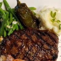 Ribeye Steak · A ribeye steak grilled to perfection served with our pickled jalapeño and steak butter and a...