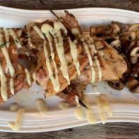 Shish Tawook · Chicken thighs grilled over an open flame served with our secret creamy garlic sauce and a c...