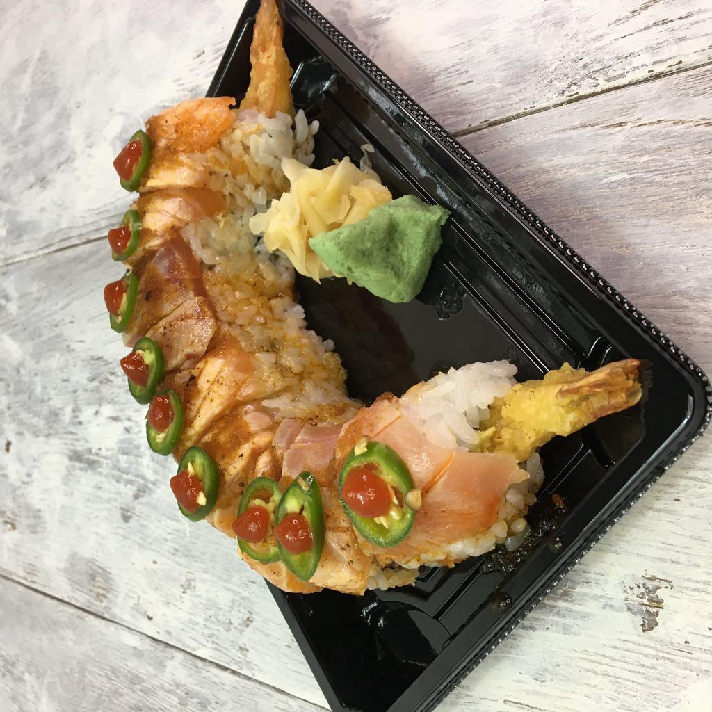 Cosmopolitan Roll · Inside stuffed with shrimp tempura, spicy tuna, and avocado. Outside seared Cajun tuna, Cajun salmon, and jalapeno.