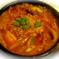 23. Kimchi Chigae · Soup dish with pork, tofu, kimchi, spicy soup and rice on the side.