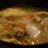 27. Deok Mandu Gook · Soup dish with rice cake, dumpling, beef, eggs and vegetables.