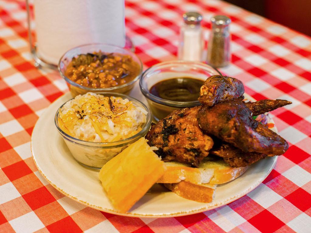 Half Chicken · Served with 2 sides, a honey corn bread and a drink.