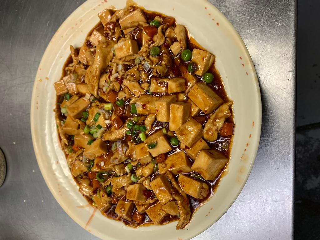 Mapo Tofu · Soft tofu, peas, carrots, green onions tossed in a spicy sauce and served with rice; Add a protein for $3.00.