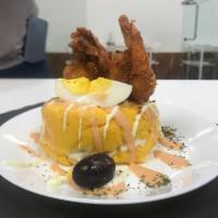 Causa de camarones · Peruvian yellow potato with tasty shrimp, avocado and red peppers...
an exquisite flavor!