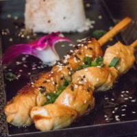 Chicken Skewers · Chicken, white rice, chieves, sesame and unagui sauce.