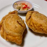 Curry Puff · Curried minced chicken, potatoes and onions in a pastry puff fried until golden brown served...