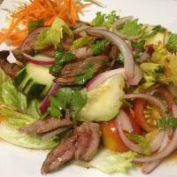 Yum Nua Beef Salad · Grilled steak sliced thin and tossed with spicy lime vinaigrette mixed with red onion, cucum...