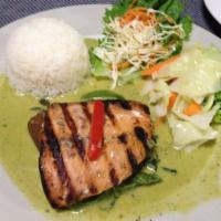 Salmon Green Curry · Salmon over green curry sauce, eggplant, bell peppers, and basil leaves with steamed vegetab...