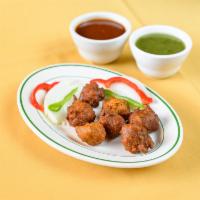 Onion Pakoda · Fried onion fritters made from a chickpea flour batter.
