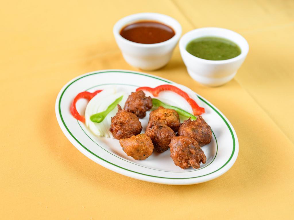 Onion Pakoda · Fried onion fritters made from a chickpea flour batter.