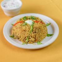 Chicken Biriyani · Deliciously spiced basmati rice cooked with boneless chicken, mint,spices and herbs.