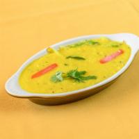 Daal Tadka · Yellow mung beans cooked with tomatoes, onion, garlic, spices and herbs.