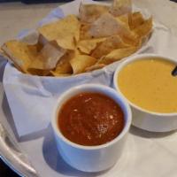 Chips and Queso  · Fresh tortilla chips served with warm queso, made with our 
