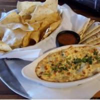 Artichoke and Goat Cheese Dip  · Oven-baked artichoke, green chile, and goat cheese dip, served with pita and tortilla chips.