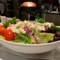 Greek Salad  · A mix of romaine and spring lettuce, tomato, Kalamata olives, red onions, feta cheese, and G...