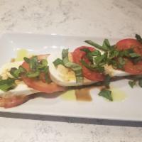Caprese Salad  · Delicate Roma tomatoes, fresh mozzarella, fresh basil leaves, topped with a drizzle of olive...