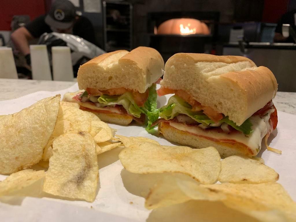 Italian Sub · Salami, pepperoni, lettuce, tomato, red onion, tomato, and our signature cheese blend drizzled with red wine vinegar, and olive oil. Served on a toasted hoagie.