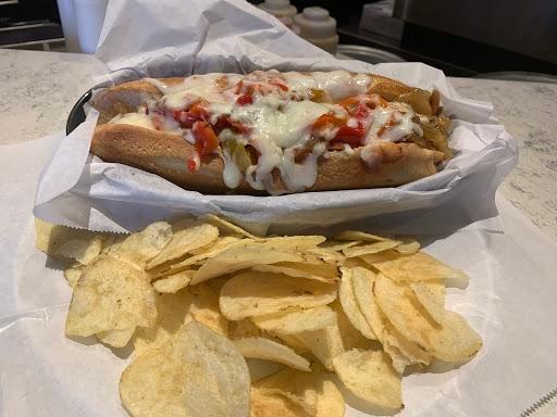 Sausage Sub · Sliced Italian link sausage, roasted red bell peppers and onions, warm marinara sauce, and our signature cheese blend, served on a toasted hoagie.
