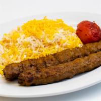 Kabob Koobideh · Two skewers of juicy, finely seasoned ground sirloin grilled on the flame.