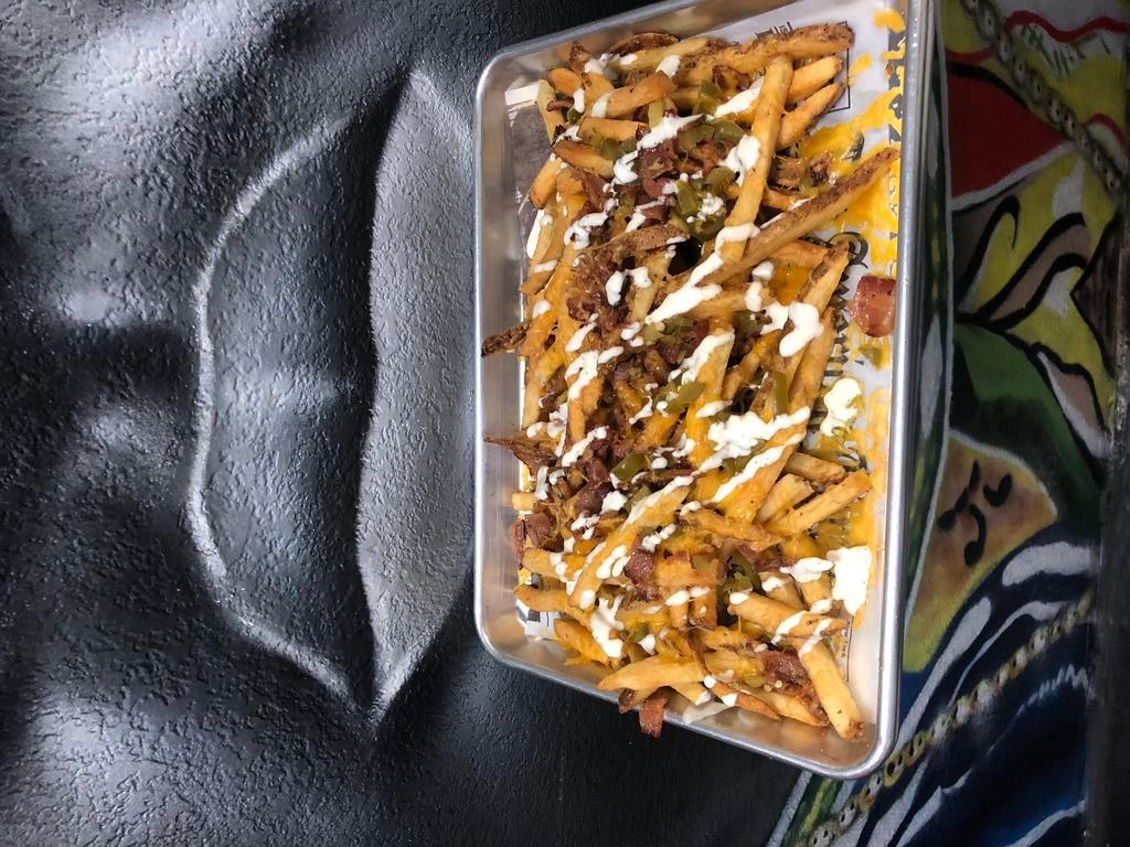 Loaded Cheese Fries · Whole lotta shredded cheddar, bacon, jalapenos & buttermilk ranch.