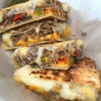 Philly Cheese Steak Quesadilla · Sauteed onions and mushrooms, peppers, steak, provolone and Jack cheese and cheese sauce.