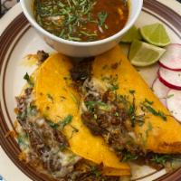 Quesabirria · 2 corn tortillas filled with birria, cheese, onion, cilantro and lightly fried, served conso...
