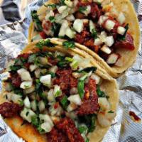 Taco de Chicharron · Pork Rinds in a savory, green, salsa