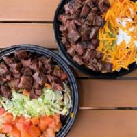South of the Border Churrasco · Chopped specially marinated steak, choice of rice, lettuce, tomato, cheese, sour cream, guac...