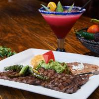 Carne Arrachera · Broiled thinly sliced skirt steak, served with jalapeno, grilled green onion, fresh guacamol...