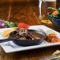 Cordero · Served with 1 side, your choice of beans, rice, nopales, or vegetables. Bone-in lamb, rubbed...