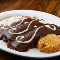 Enchilada de Mole · Stuffed with chicken, Mole poblano sauce and topped with Mexican crema.