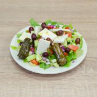 Catering Greek Salad · Lettuce, tomatoes, cucumbers, red onions, feta cheese, Kalamata olives and stuffed grape lea...