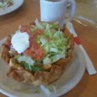 Shredded Chicken Taco Salad · Crispy tortilla bowl filled with cheese dip, lettuce, tomatoes, sour cream and shredded chee...