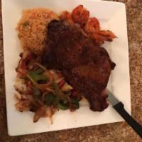 Steak Tejano · 8 oz. steak and 6 sauteed garlic shrimp cooked with onions, bell pepper. Served with rice, b...