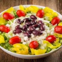 Greek Salad · Romaine and iceberg lettuce, spinach leaves, feta cheese, green peppers, Greek olives, banan...