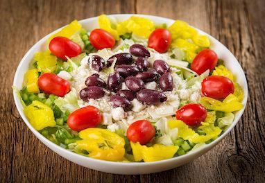Greek Salad · Romaine and iceberg lettuce, spinach leaves, feta cheese, green peppers, Greek olives, banana peppers, cucumbers, grape tomatoes and shaved Asiago cheese.