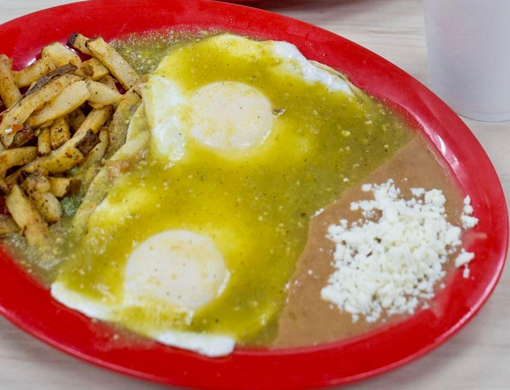 Huevos Rancheros · 2 eggs topped with green salsa served with refried beans, fresh white cheese and breakfast potatoes.