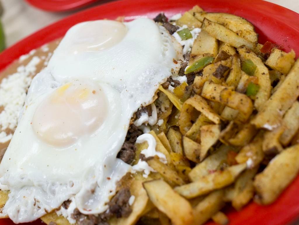 Huevos Rancheros Especial · 2 eggs topped with choice of meat and green salsa served with refried beans, fresh white cheese and breakfast potatoes.