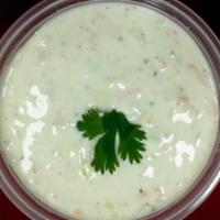 Raita · Yogurt, lightly spiced with cucumbers and carrots.