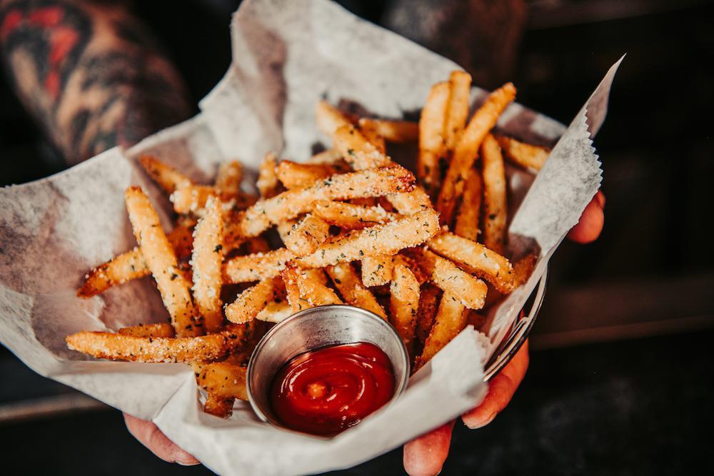 Truffle Fries · Dusted with parmesan & herb, truffle oil, and served with garlic aioli