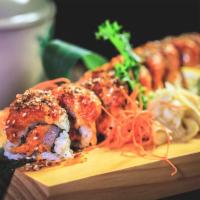 Angry Ocean Roll · Spicy salmon, yellowtail with crunch inside and spicy tuna with bonito flakes on top.