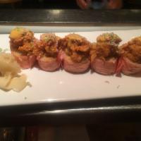 Midtown Roll · Spicy scallop, avocado and tempura flakes wrapped around spicy tuna and rice cracker, wrappe...